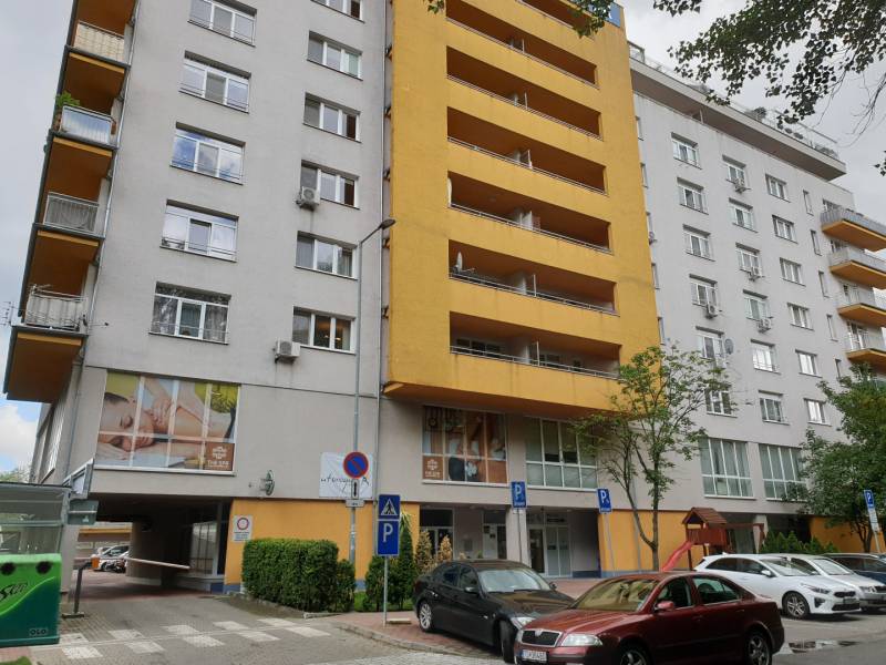Apartment building in Bratislava on Antolská Street with parking and a children's playground.