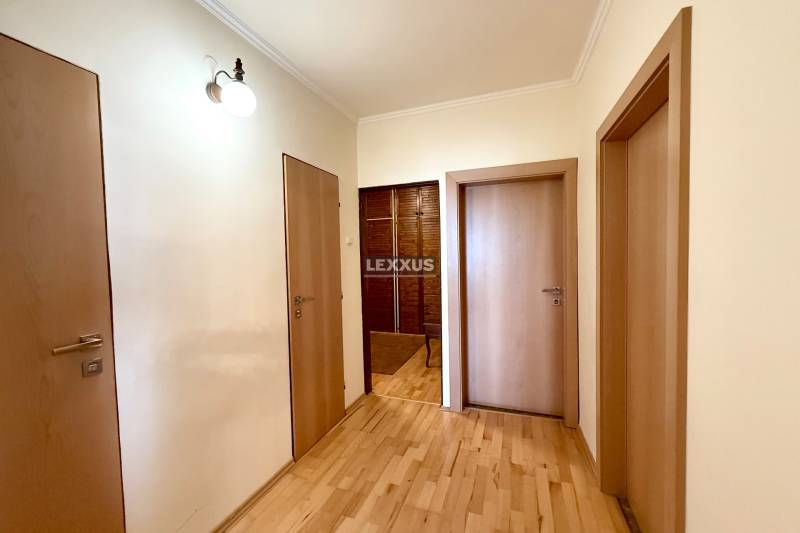 A hallway with wooden doors and light walls in a 3-room apartment.