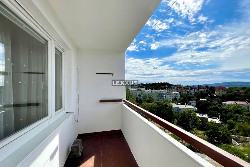 A balcony with a view of the rooftops of the Old Town in Bratislava, a 3-room apartment on Bartókova.