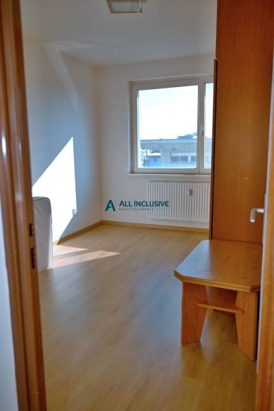 A room in a 3-room apartment with a wooden floor and a table with a view.