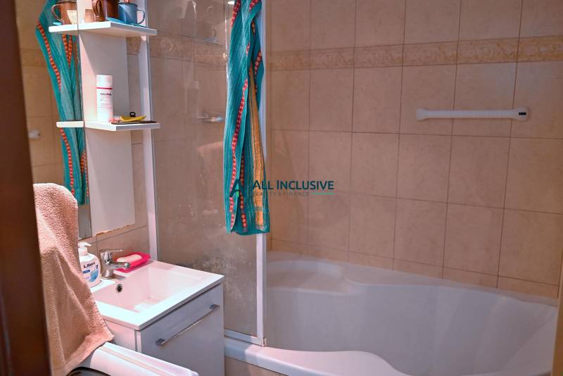 Bathroom with a shower and a white sink in a 3-room apartment.
