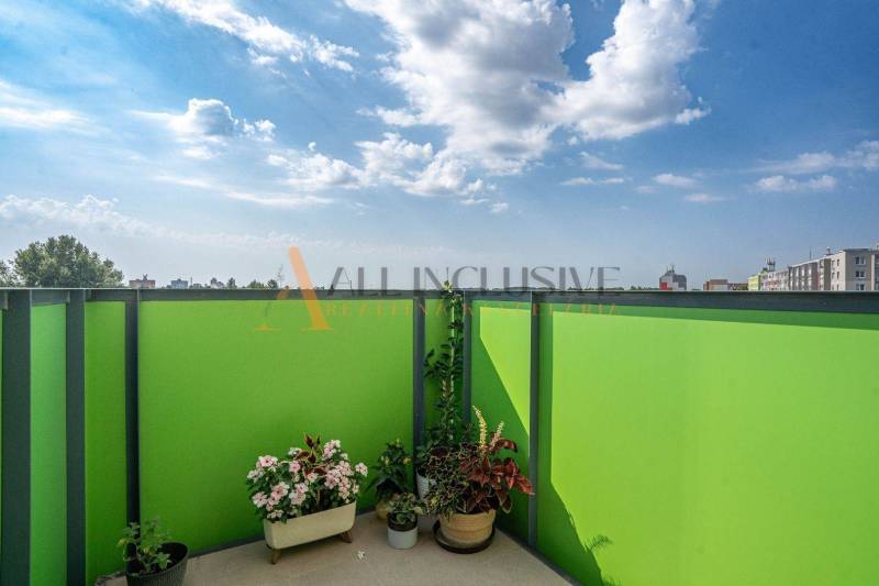 A balcony with flowers and a view of the city in Sereď, Galanta Street, 2-room apartment.