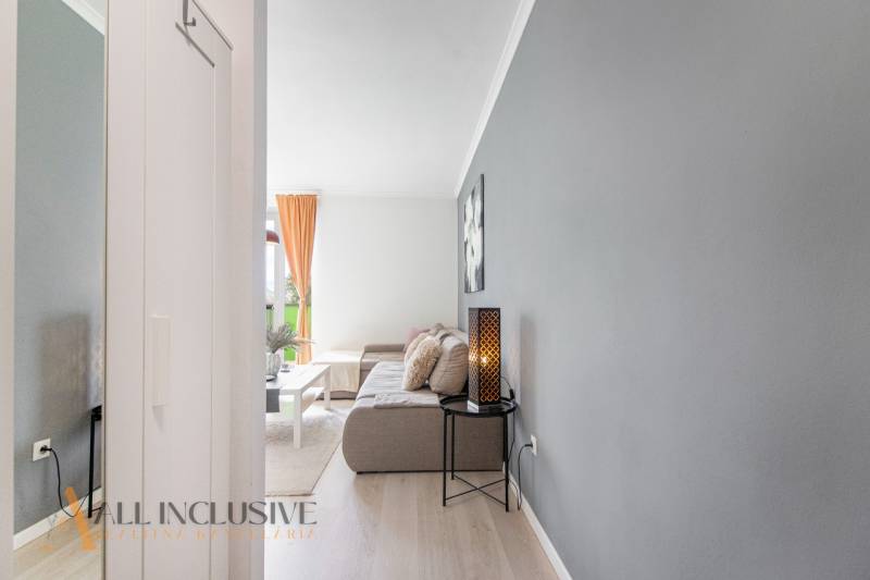 Living room in a two-room apartment with a decorative lamp and a sofa.