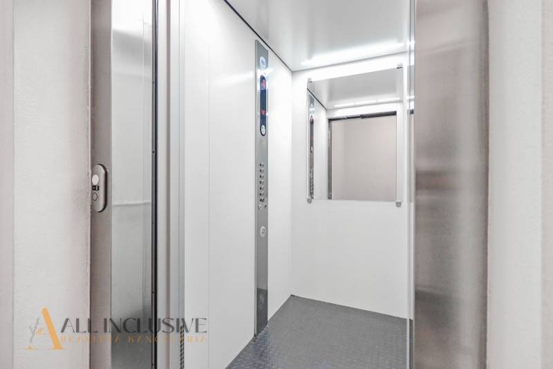 The interior of an elevator with lighting and a control panel in a 2-room apartment.
