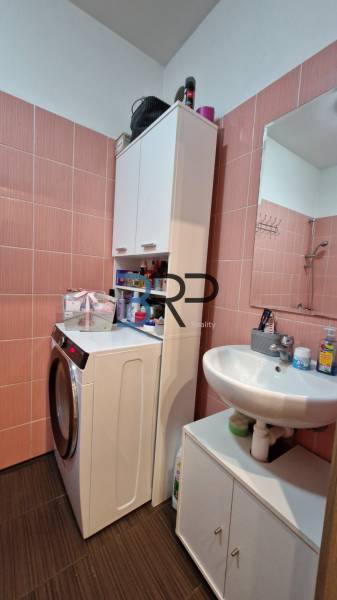 Bathroom and 3-room apartment with a washing machine in a compact space with cabinets.