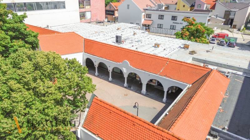 Commercial premises in Dunajská Streda with arches and red roofs near the development.