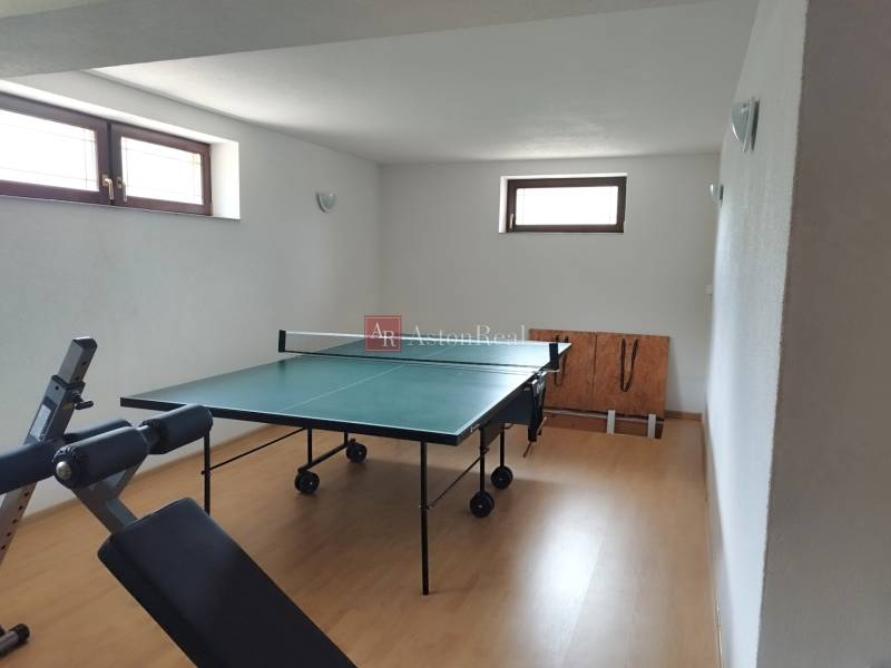 Ping pong table and exercise machine in a family house.