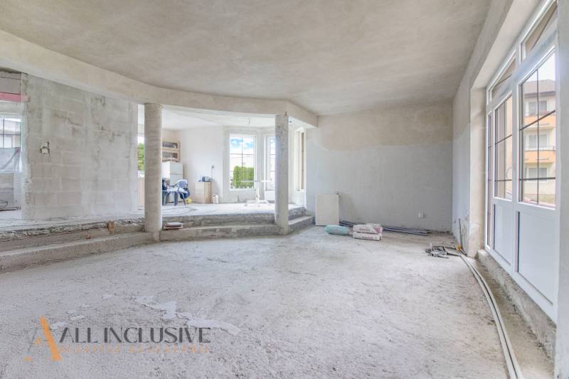 Interior of an incomplete family house with open space and empty floor.