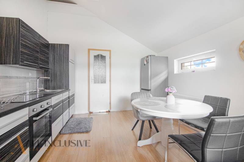 A kitchen in a family house, modern furnishings, dining table, and stylish kitchen unit.