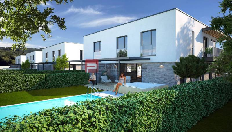 In Dubová, there are white buildings with a pool in front of 3-room apartments.