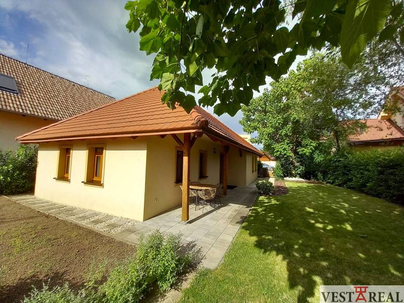 A family house on Atletická Street in Biely Kostol surrounded by a garden and trees.