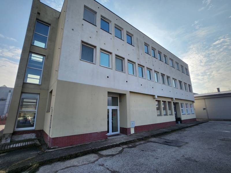 The building on Továrenská Street in Smolenice with a row of windows.
