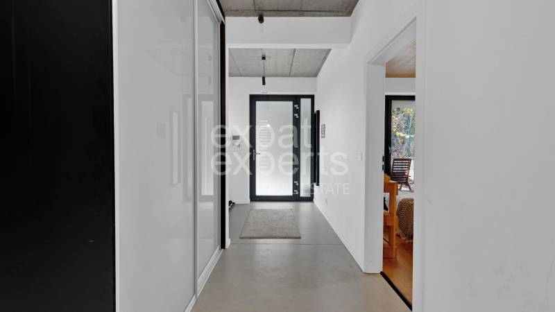 Interior of a family house with light walls, a hallway, and simple decor.