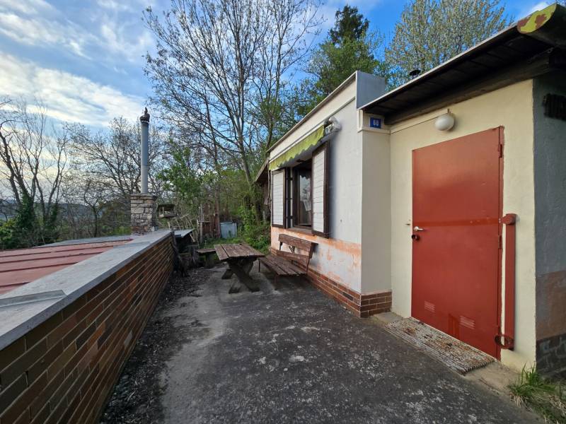 A cottage on Sychrov Street in Beckov with an outdoor seating area by the table and chimney.