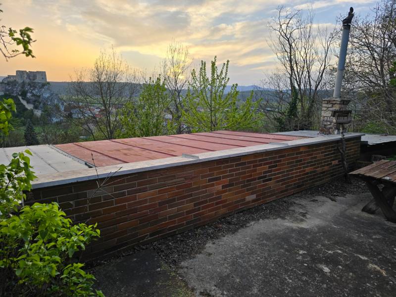 An evening view of the terrace at the cottage in Beckov at Sychrov with a view of the castle.
