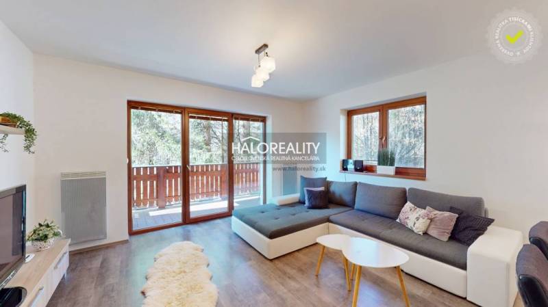 A bright living room with a large window, a sofa set, and wooden flooring in a 3-room apartment.