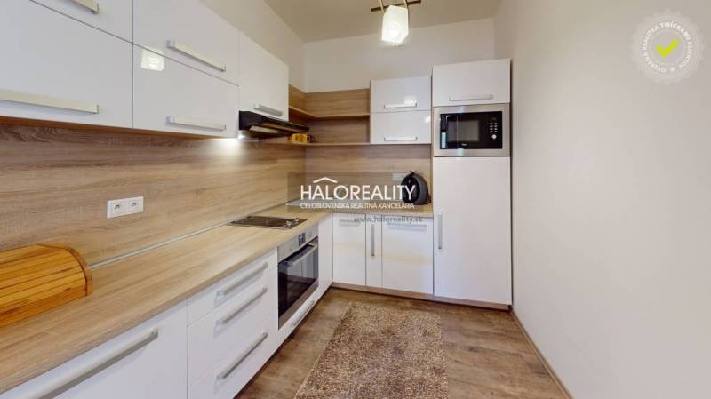A kitchen with wooden details and appliances in a 3-room apartment, light cabinet set.
