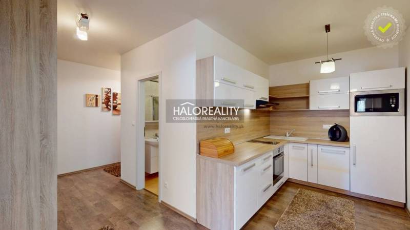 A kitchen in a 3-room apartment with compact kitchen equipment and appliances.