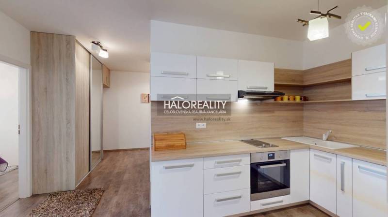 A kitchen in a 3-room apartment with a built-in kitchen unit and a built-in wardrobe, wooden floors.