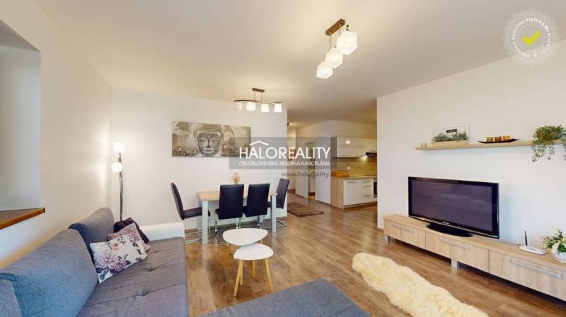 Living room in a 3-room apartment with a sofa, dining table, and television.