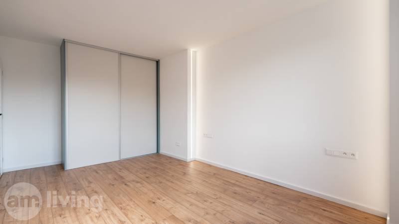 Spacious room with wooden floor and built-in wardrobe in a 2-room apartment.