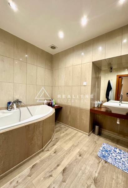 Bathroom in a 2-room apartment with a bathtub and ceramic tiles.
