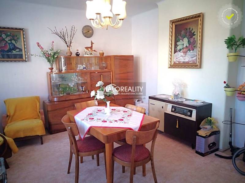 Living room of a family house with a dining table, armchair, and furniture.
