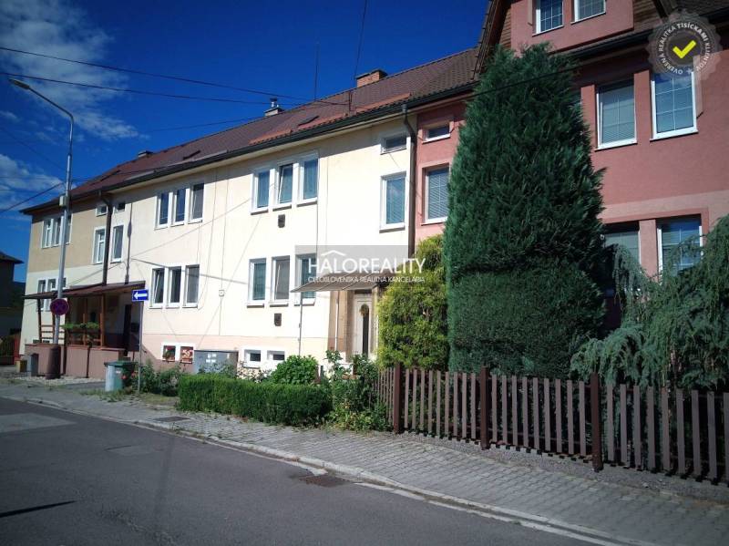 A terraced family house in Nováky with a landscaped garden and front yard on a quiet street.