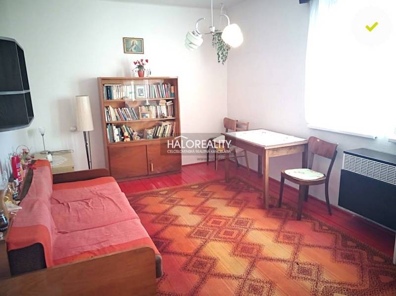 Living room in a family house with a sofa set and a bookshelf.
