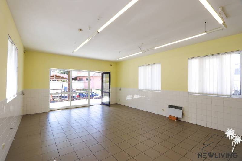 Spacious commercial spaces with large windows, tiles, and plenty of natural light.
