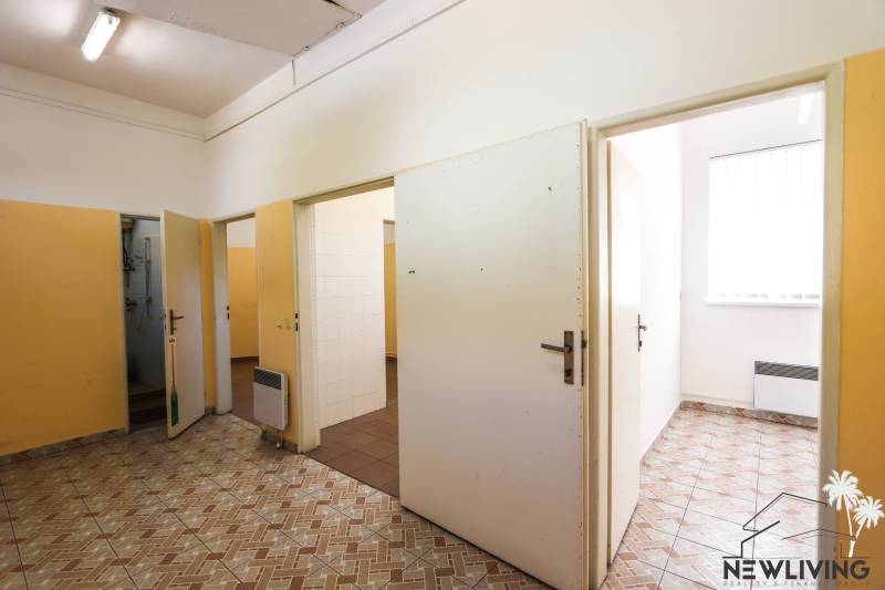 Commercial premises with multiple rooms, tiles, and white doors.