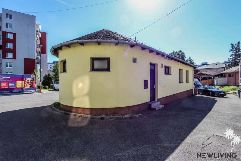 A yellow round building between residential houses on Slovenského národného povstania Street in Vrbové.