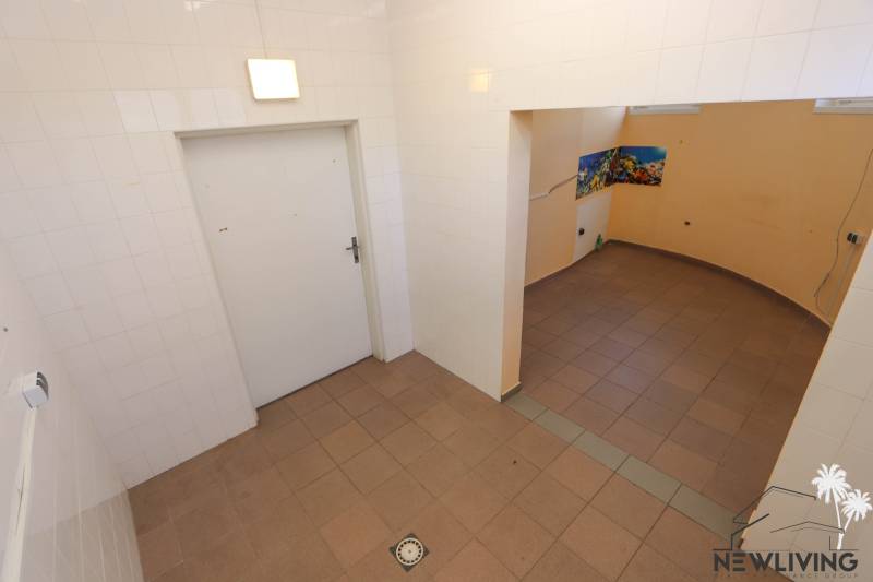 Tiled room with an opening to the adjacent section, commercial spaces with floor tiles.