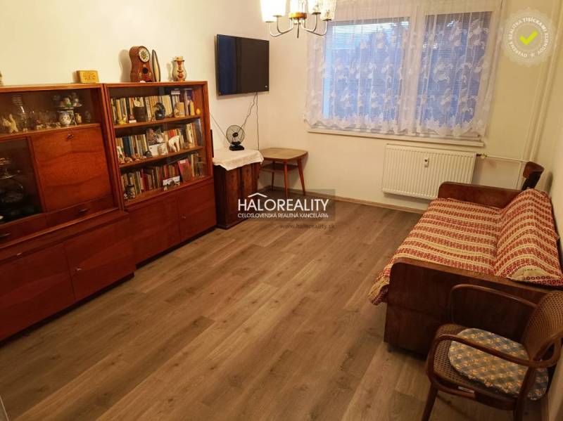 A nice living space with a sofa and a bookshelf in a 2-room apartment, wooden floor.