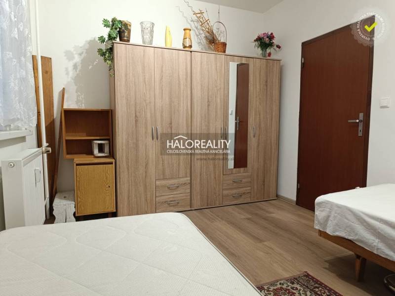 A cozy room with wooden furniture in a 2-room apartment, suitable for peaceful living.