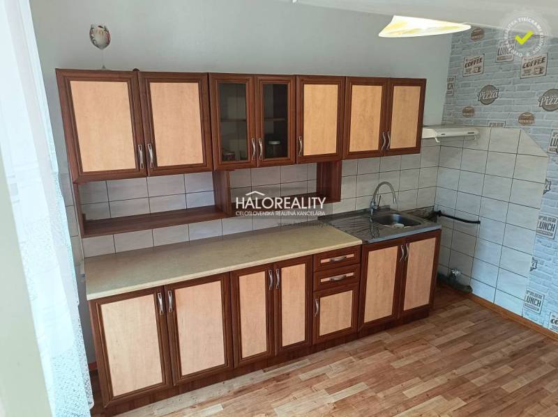 A kitchen in a 3-room apartment with cabinets, a countertop, and a sink.