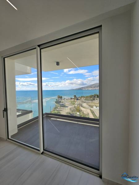 View from a holiday apartment in Sarandë to the coast and blue sky.