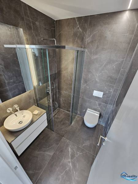 Bathroom of the Holiday Apartment with a spacious shower and modern amenities.