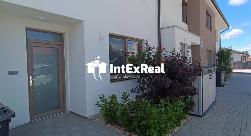 The entrance of a family house with wooden doors and a garden on Veterná Street in Galanta.