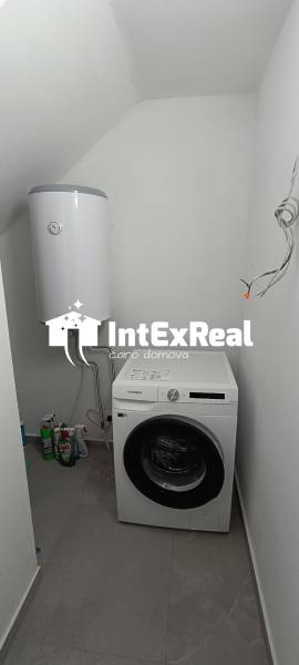 Laundry room in a 2-room apartment with a washing machine and a boiler.
