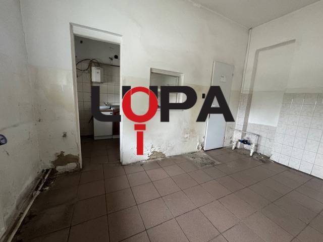 The interior of the building with damaged walls and tiles, suitable for renovation.