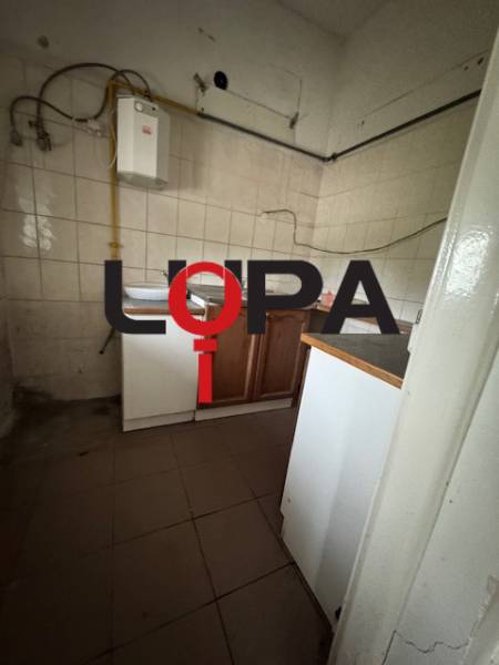 A small kitchenette with a gas boiler in commercial premises.