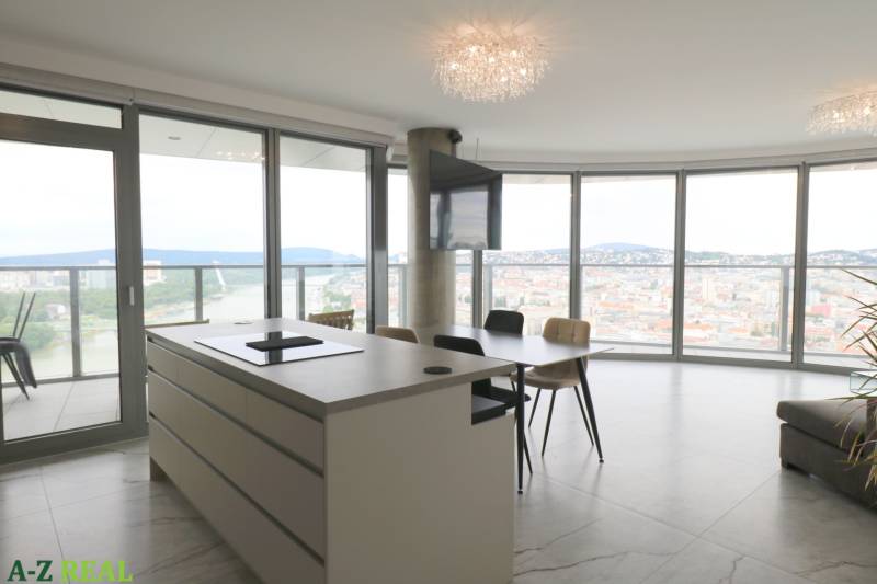 A kitchen with an island, a dining table, and a panoramic view in a 3-room apartment.