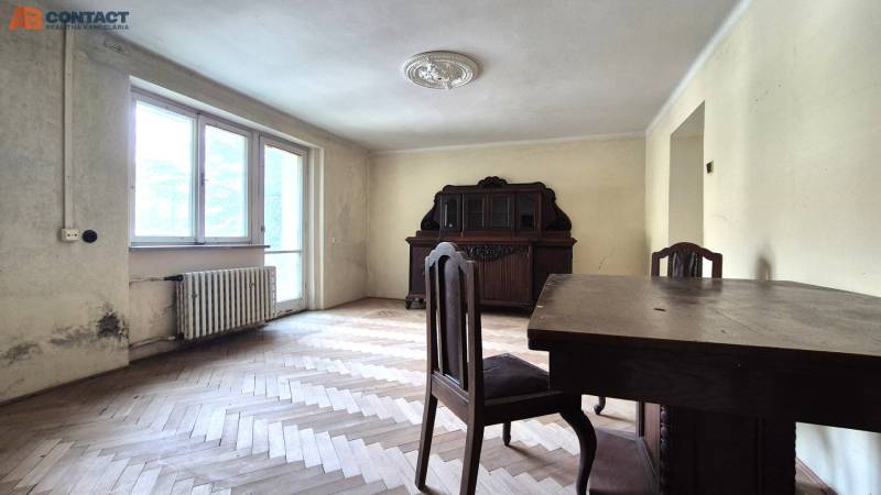 A room with wooden furniture and parquet floors in a 3-room apartment.