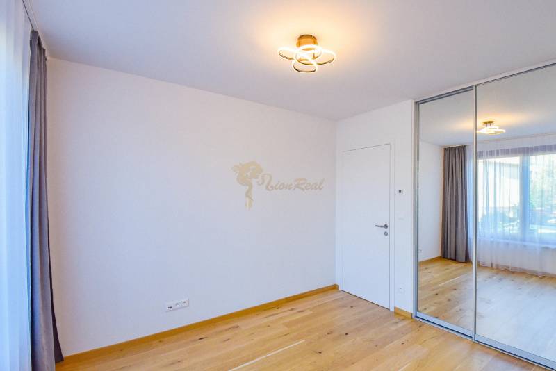 A room with a wooden floor and a built-in wardrobe in a 3-room apartment.