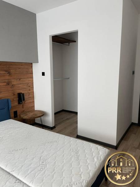 Bedroom interior with a bed and built-in wardrobe in a 3-room apartment.