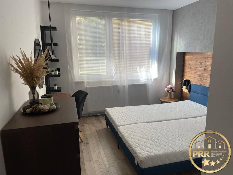 A bright bedroom in a 3-room apartment with a bed and wooden details.