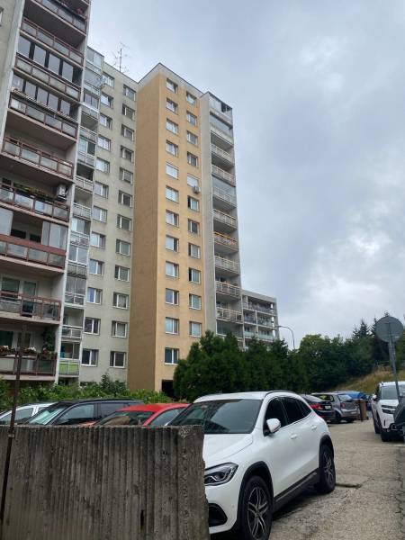 Apartment building on Rozvodná Street in Bratislava - Nové Mesto, parking lot in the foreground.