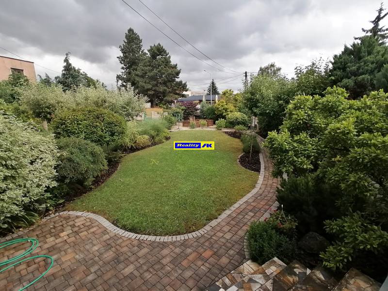 A garden at a family house on J.Š.Šikuru Street in Martin with a walkway and greenery.