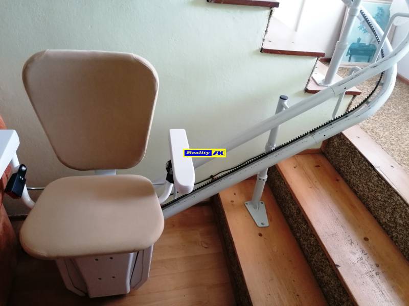 A stairlift in a family house makes it easier to move up and down the stairs.